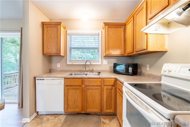 kitchen with sink, white appliances, and light tile patterned flooring