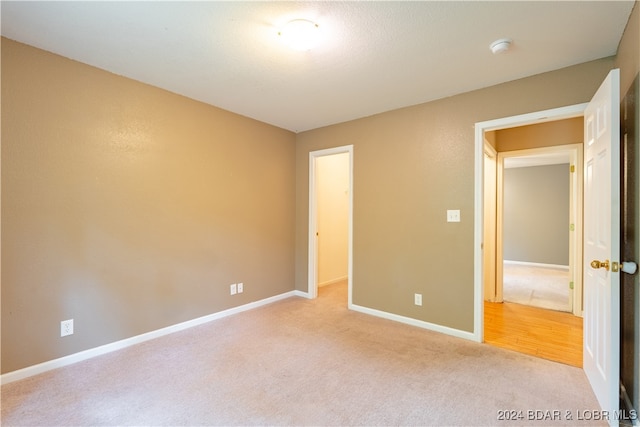 unfurnished bedroom featuring light colored carpet