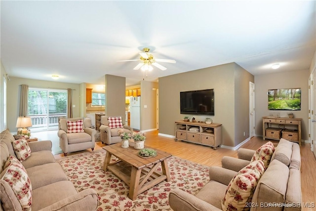 living room featuring ceiling fan and light wood-type flooring