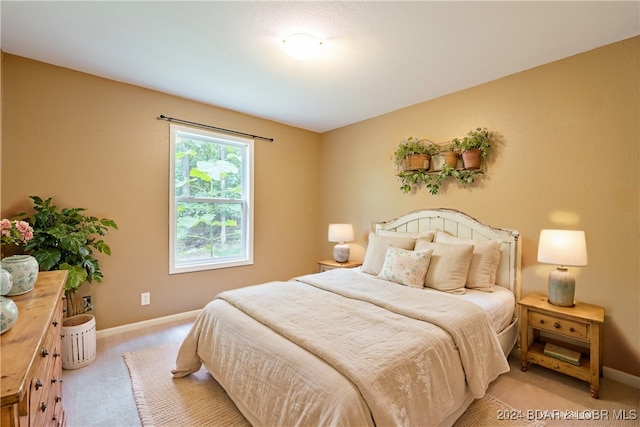 bedroom featuring light colored carpet