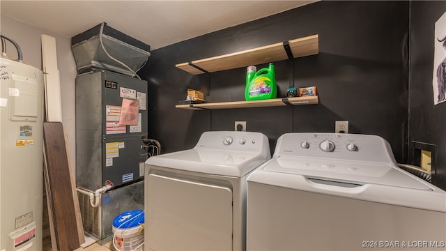 laundry area with water heater and separate washer and dryer