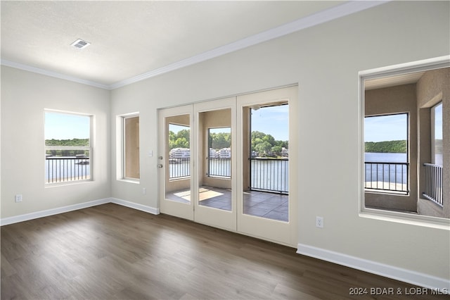 spare room with crown molding and wood-type flooring