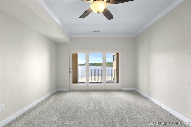 carpeted spare room featuring ceiling fan and ornamental molding