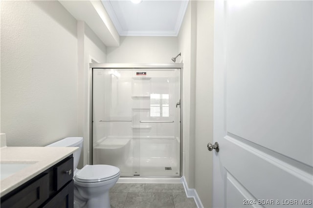 bathroom featuring toilet, tile patterned flooring, vanity, walk in shower, and crown molding