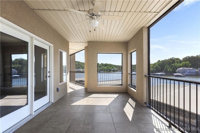 unfurnished sunroom with ceiling fan and wood ceiling