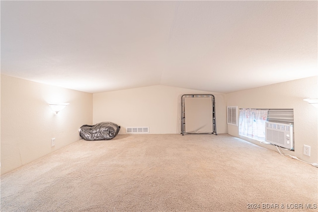 additional living space featuring cooling unit, light colored carpet, and lofted ceiling