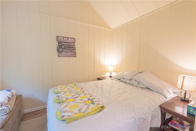 bedroom with lofted ceiling and hardwood / wood-style floors