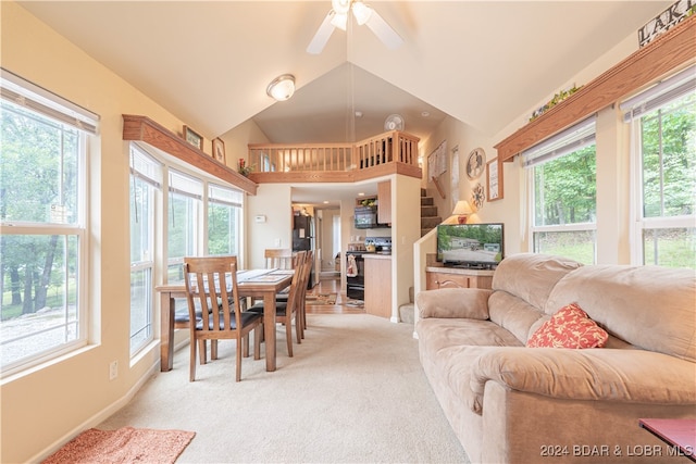 living room featuring ceiling fan, light carpet, and a healthy amount of sunlight