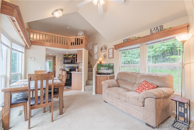 living room featuring ceiling fan, light carpet, high vaulted ceiling, and a healthy amount of sunlight