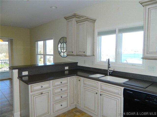 kitchen with a wealth of natural light, sink, kitchen peninsula, and dishwasher