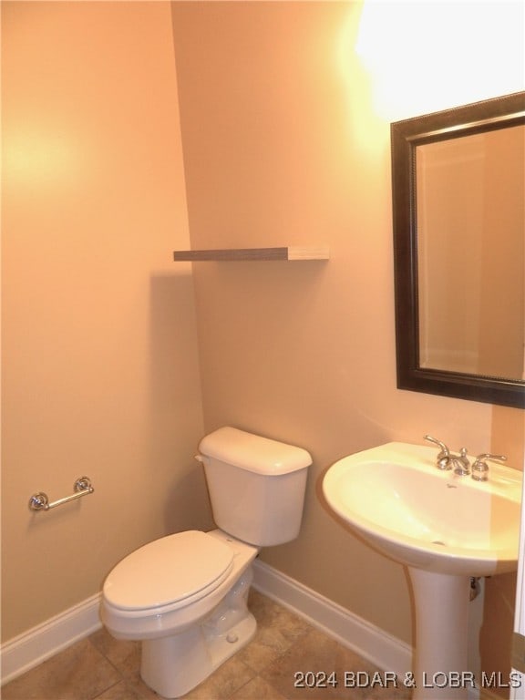 bathroom featuring toilet and tile patterned floors