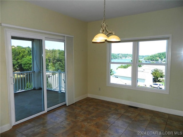 interior space with baseboards, visible vents, and a healthy amount of sunlight