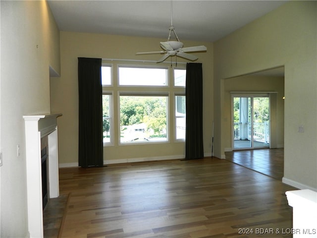 unfurnished living room featuring ceiling fan and hardwood / wood-style flooring