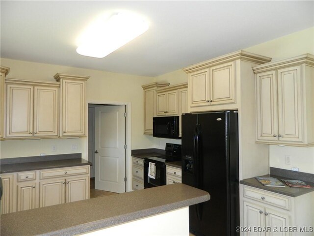 kitchen with cream cabinetry and black appliances