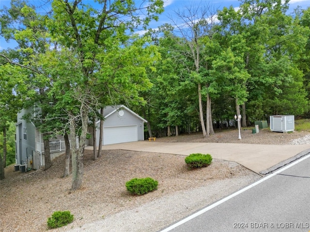 obstructed view of property featuring an outdoor structure and a garage