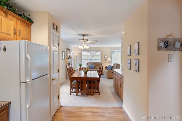 dining room featuring light colored carpet and ceiling fan