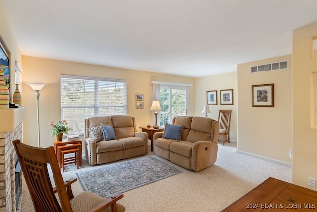 carpeted living room featuring a fireplace