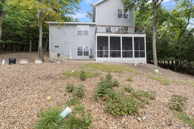 back of property with a sunroom