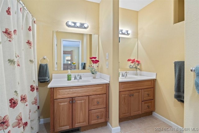 bathroom featuring dual bowl vanity and tile patterned floors