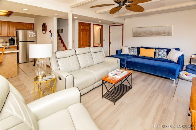 living room featuring light wood-type flooring and ceiling fan