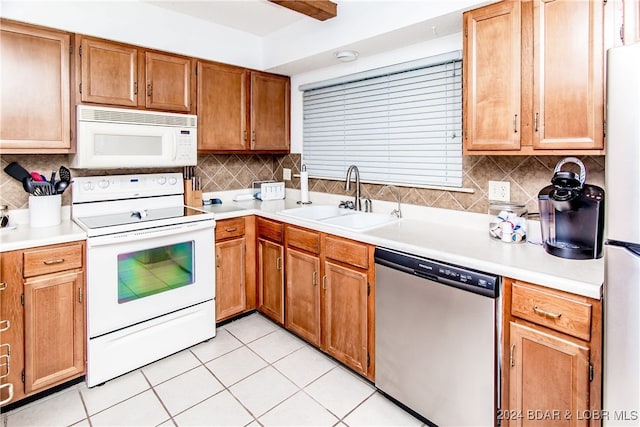 kitchen with backsplash, sink, white appliances, and light tile patterned flooring