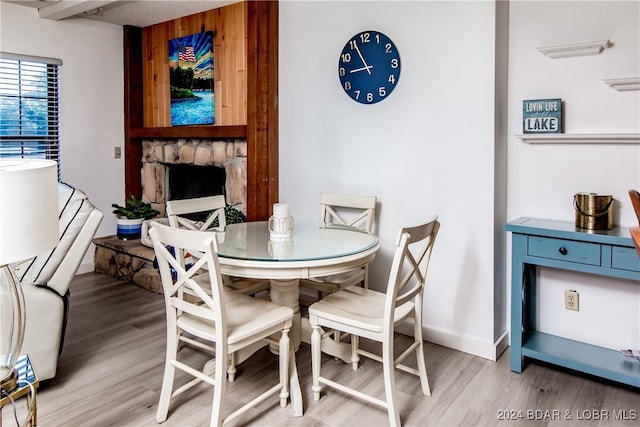 dining space featuring hardwood / wood-style floors and a fireplace