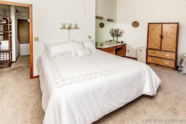 bedroom featuring light carpet and a walk in closet