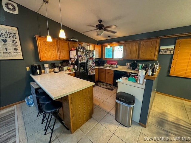 kitchen with black appliances, hanging light fixtures, kitchen peninsula, ceiling fan, and a breakfast bar area