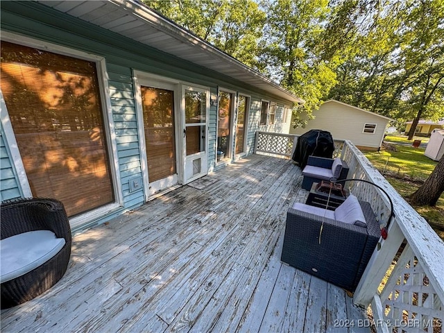 wooden deck featuring a grill