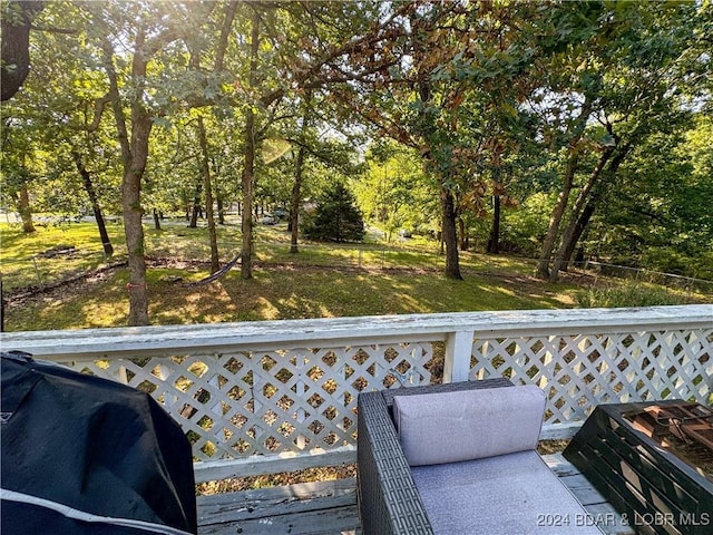 wooden terrace with a grill