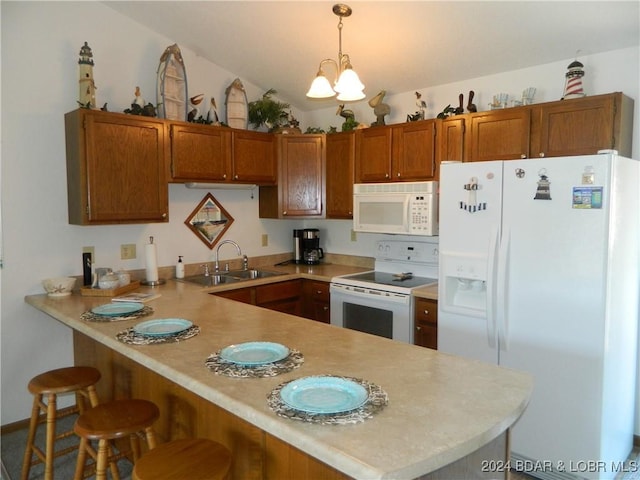 kitchen with light countertops, a peninsula, brown cabinetry, white appliances, and a sink