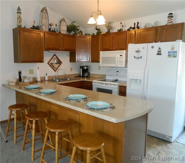 kitchen with a sink, white appliances, a peninsula, brown cabinetry, and light countertops