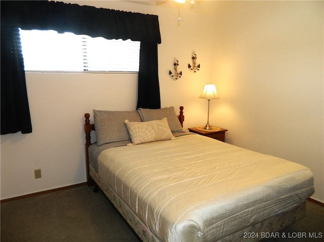 bedroom featuring baseboards and carpet