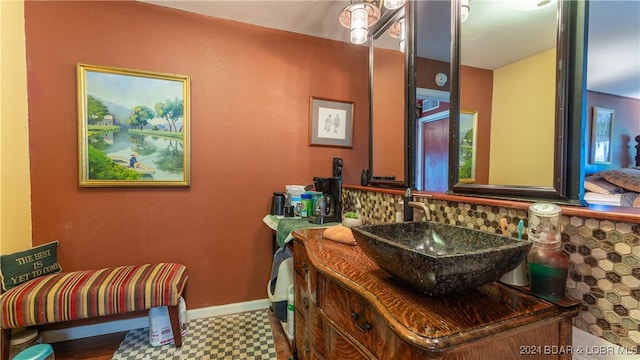 bathroom featuring tasteful backsplash and vanity