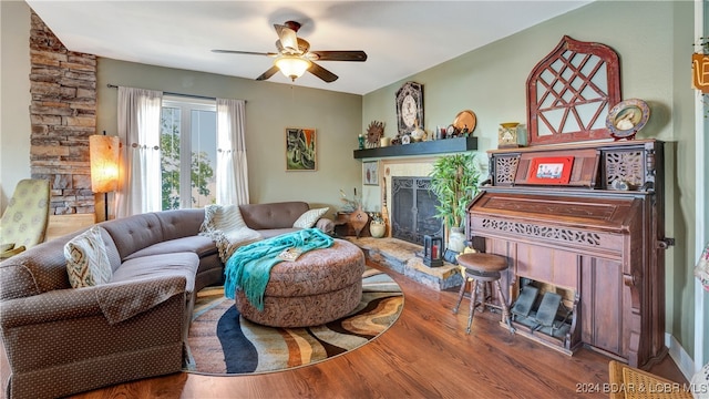 living room featuring ceiling fan and hardwood / wood-style flooring