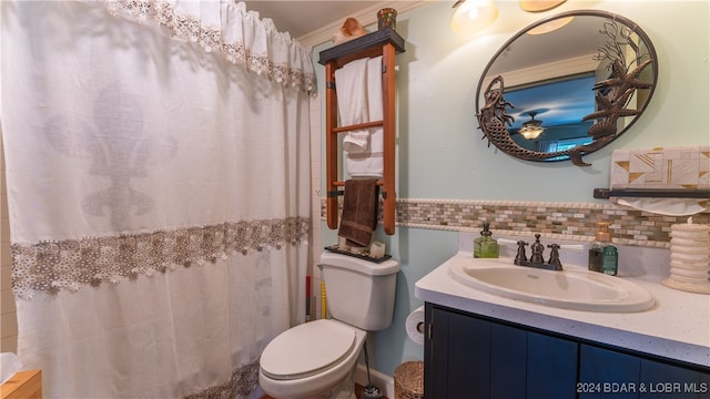 bathroom featuring backsplash, vanity, and toilet