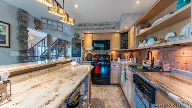 kitchen with backsplash, sink, black appliances, pendant lighting, and butcher block countertops