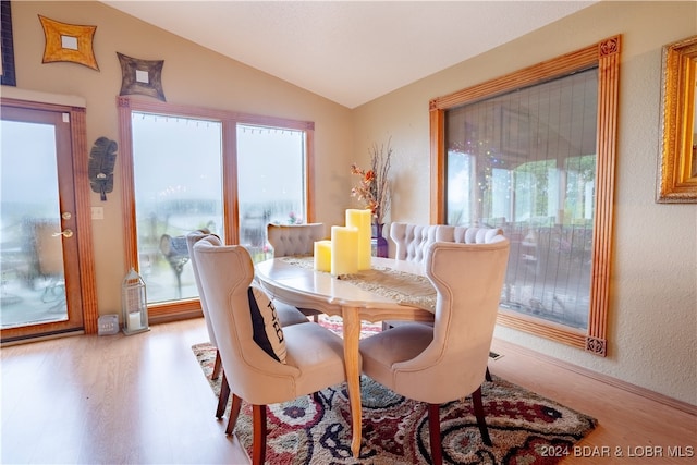 dining area with lofted ceiling and wood finished floors