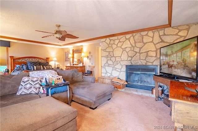 carpeted bedroom with ornamental molding, a textured ceiling, ceiling fan, and a stone fireplace