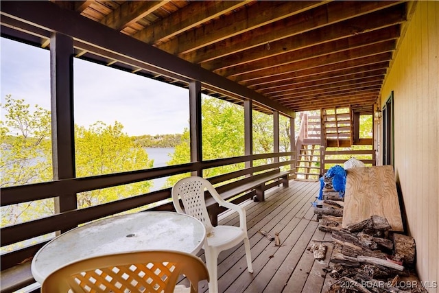 wooden terrace featuring a water view