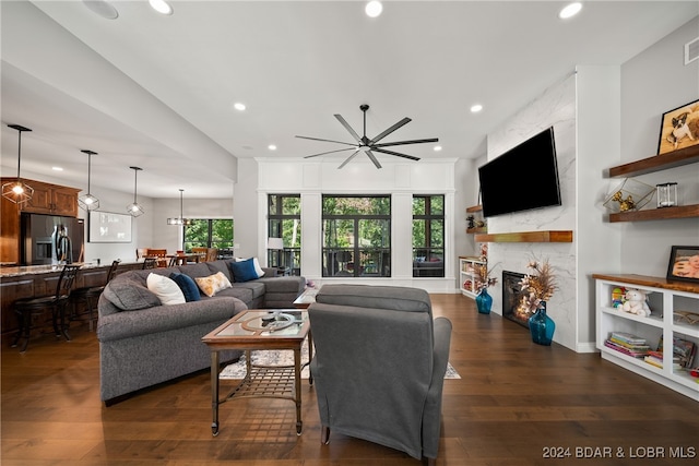 living room with plenty of natural light, dark hardwood / wood-style floors, and a fireplace