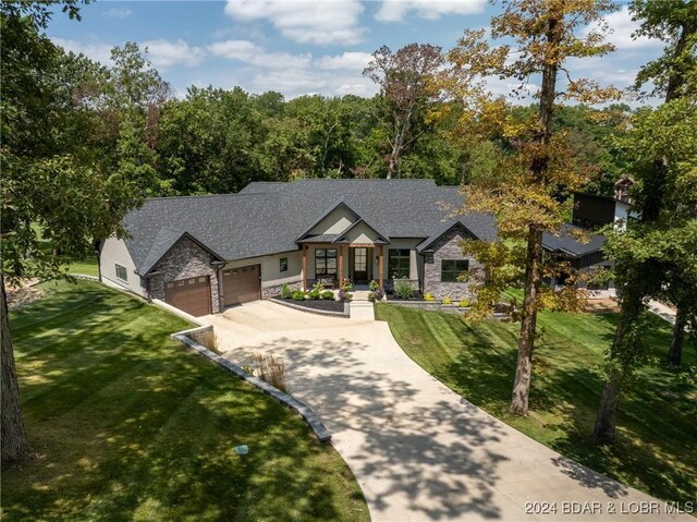 craftsman house featuring a front yard and a garage