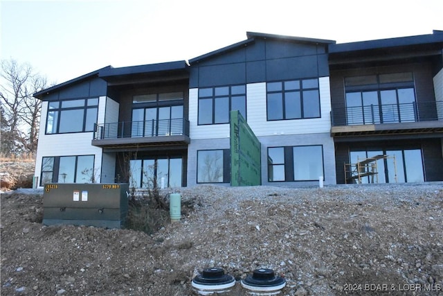 rear view of property with a balcony