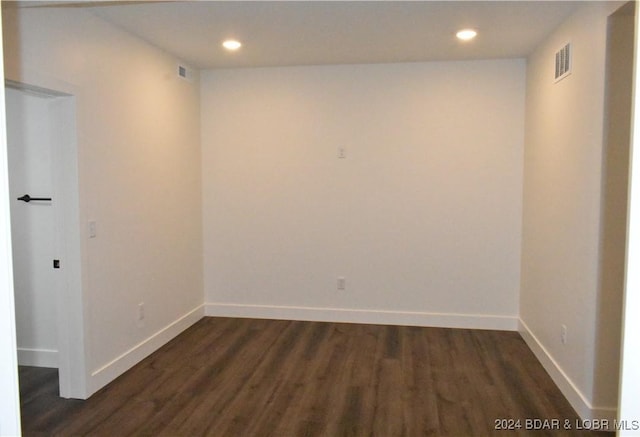 spare room with dark hardwood / wood-style floors