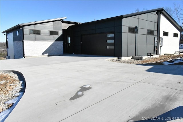 exterior space featuring a garage and concrete driveway