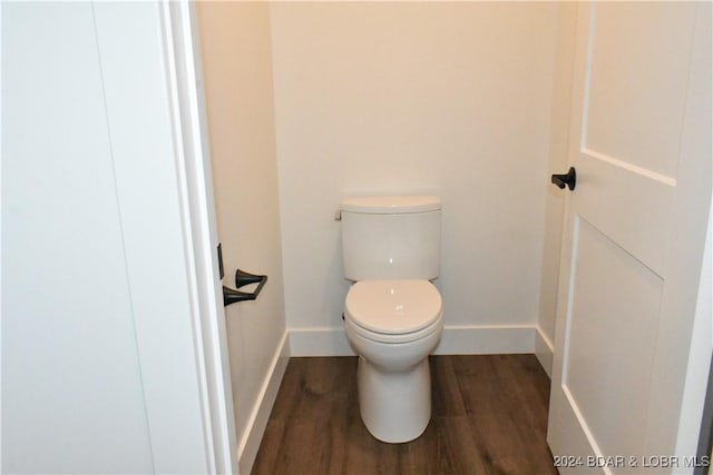 bathroom with toilet and wood-type flooring