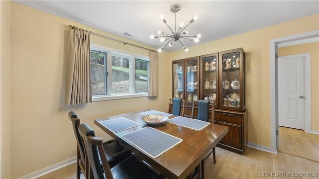 dining room featuring a chandelier and light hardwood / wood-style flooring