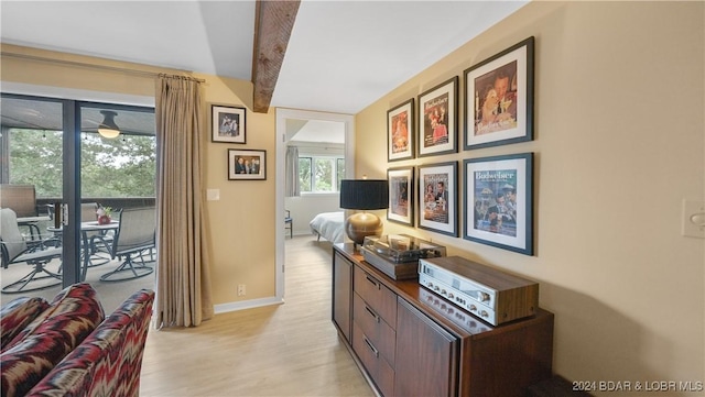 hall featuring light wood-type flooring and baseboards