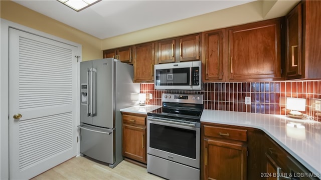 kitchen featuring stainless steel appliances and backsplash