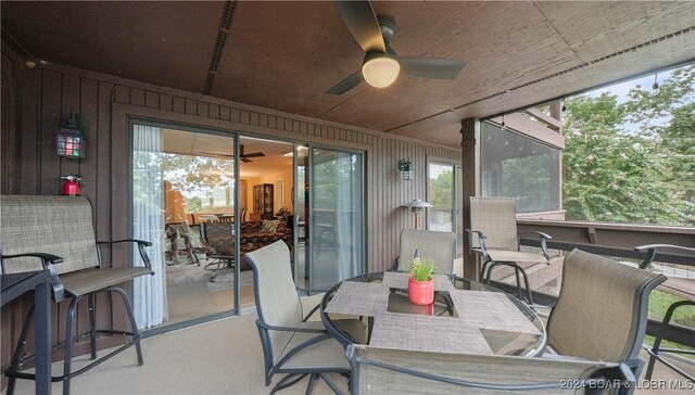 sunroom with a wealth of natural light and ceiling fan